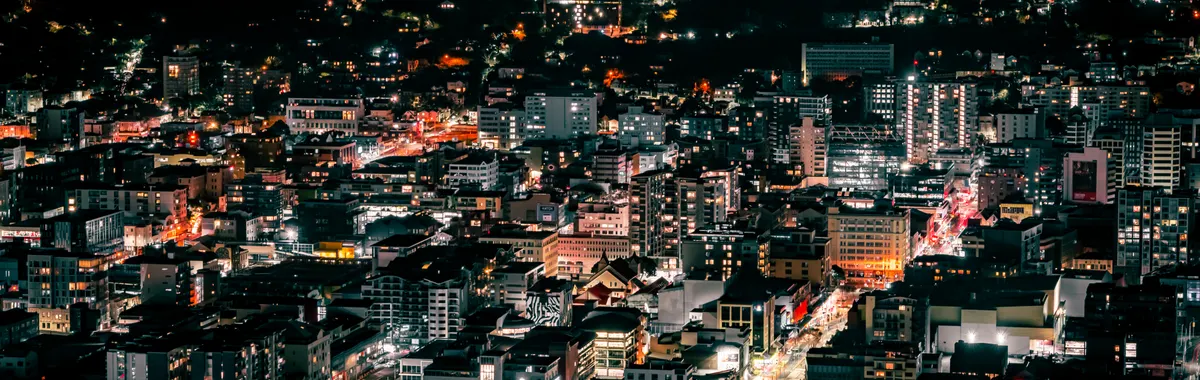 A stunning aerial view of Wellington's vibrant and illuminated cityscape during the night.