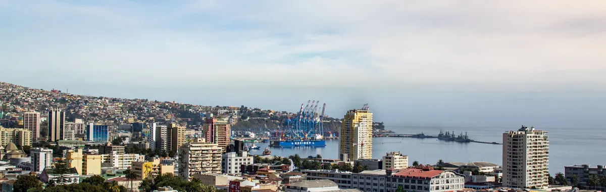 A scenic aerial view of Valparaíso, Chile, showcasing the city's vibrant architecture and bustling port.