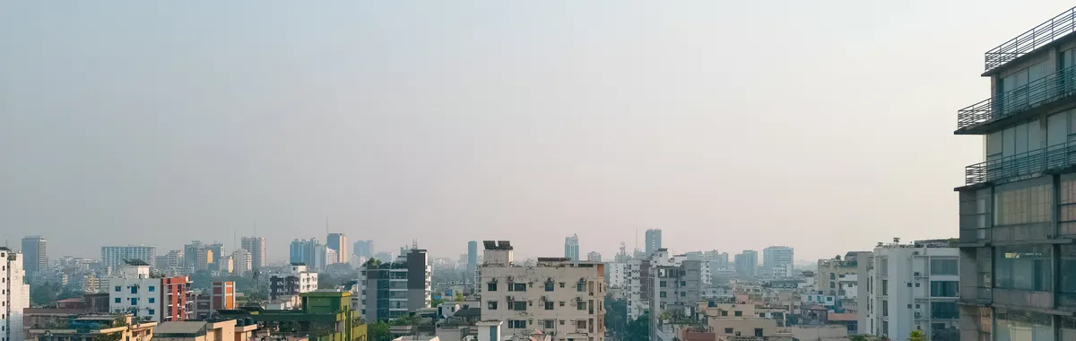 Captivating view of Dhaka's high-rise buildings under a foggy sky, showcasing modern urban architecture.