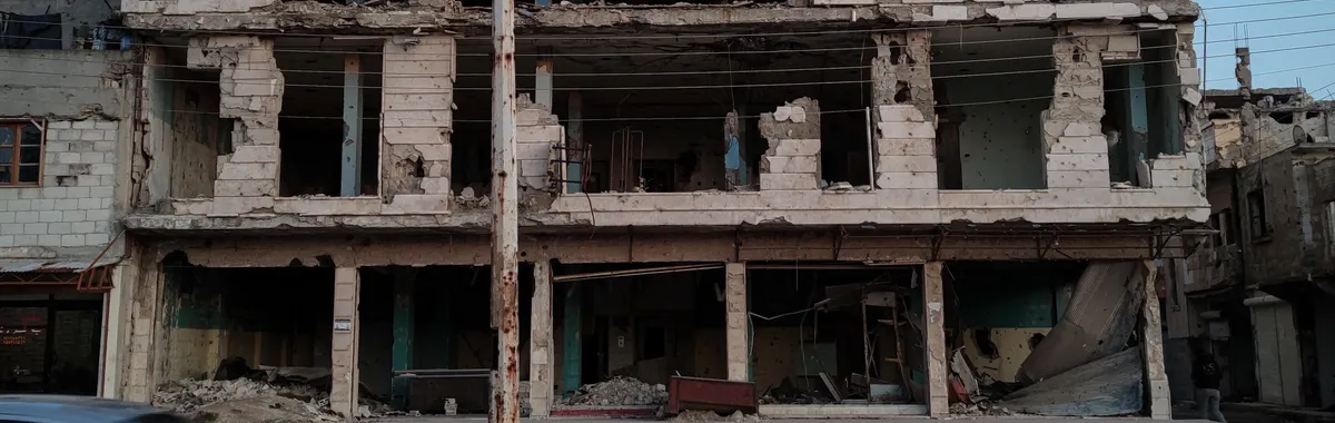 A damaged building in Homs, Syria, showing the scars of conflict.