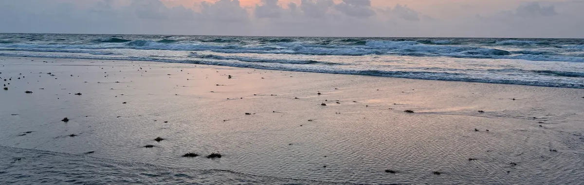Serene sunset over the ocean at Boca Raton, Florida, with waves and a pastel sky creating a peaceful scene.