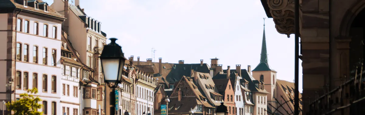 Capture of Strasbourg's historical Old Town showcasing charming architecture along a canal under a clear sky.