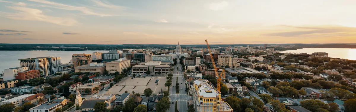 Stunning aerial view of Madison, Wisconsin cityscape at sunset with the Capitol building.