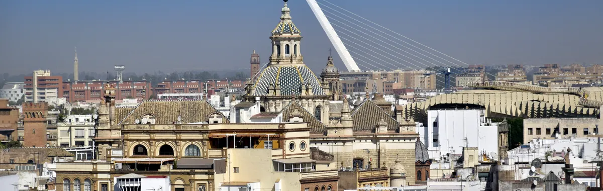 Elevated view of Sevilla's skyline showcasing historic architecture and the Puente del Alamillo.