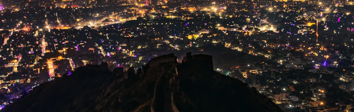 Captivating cityscape of Jaipur at night, seen from Nahargarh Fort's hilltop.