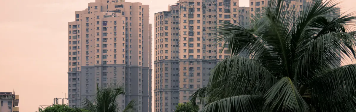 Skyscrapers and lush palm trees in Kolkata, India, at daytime.