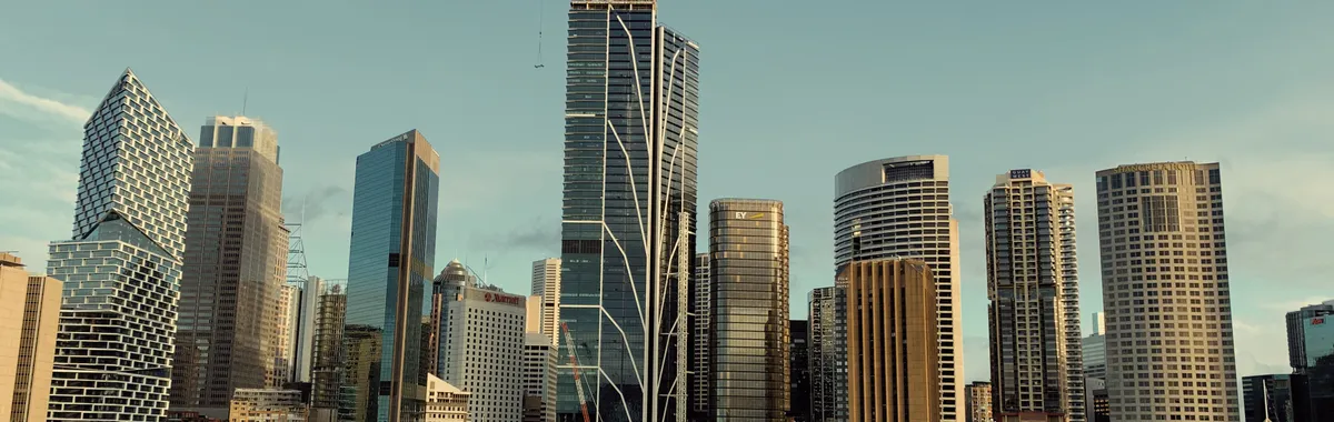 A stunning view of Sydney's skyline featuring modern skyscrapers and iconic architecture under a blue sky.