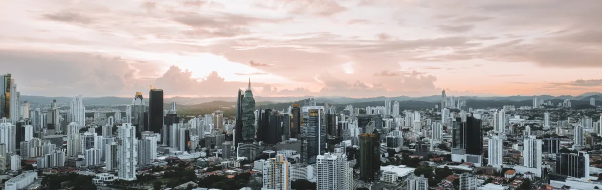 Dramatic aerial view of Panama City skyline during sunset showcasing modern skyscrapers.