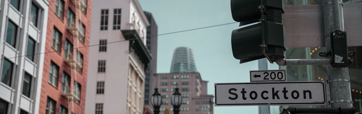Street view of San Francisco with Stockton sign and urban architecture.