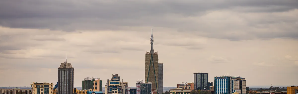 Explore the vibrant skyline of Nairobi with its modern skyscrapers under an overcast sky.