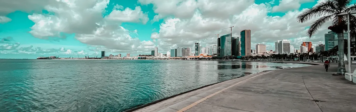 Beautiful bayfront view of Luanda, Angola with clouds and skyline reflection.