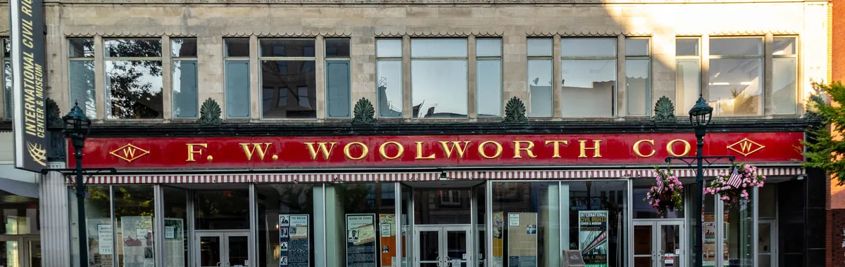 Front view of historic F.W. Woolworth building, Greensboro, North Carolina, highlighting its iconic signage and architecture.