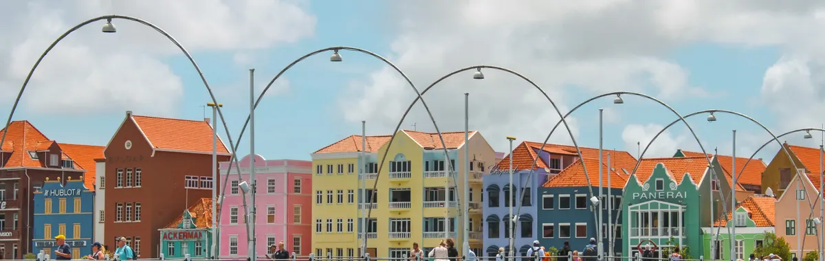 Colorful historic buildings and Queen Emma Bridge in Willemstad, a top travel destination in Curaçao.