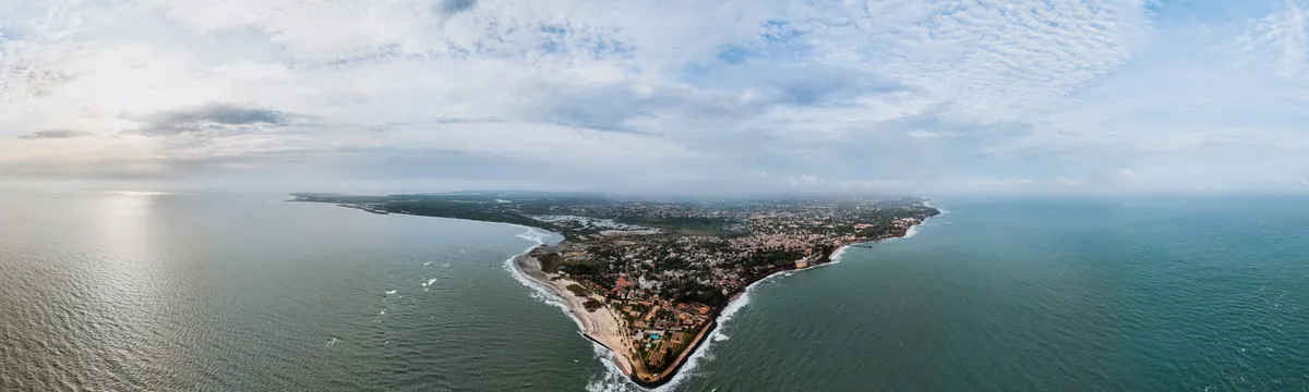גמביה: Stunning aerial view of Banjul, The Gambia's scenic coastline under a cloudy sky.