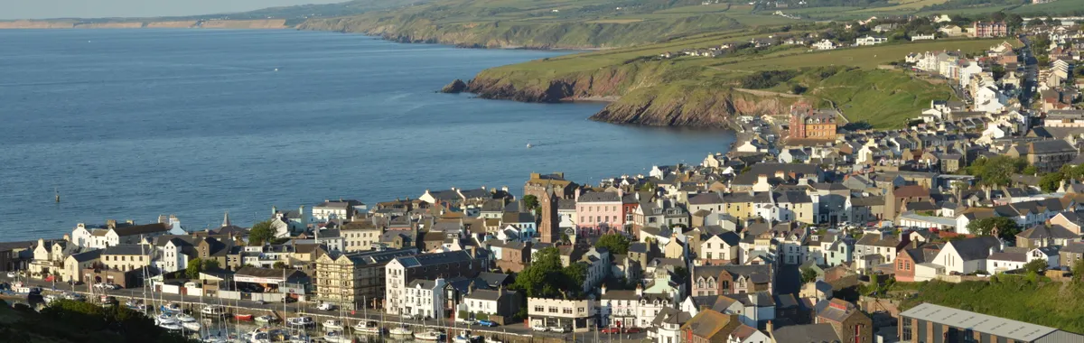 האי מאן: A picturesque view of Peel marina and town on the Isle of Man, showcasing the coastline.