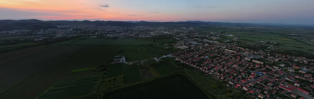 Scenic aerial view of Stara Zagora, Bulgaria during sunset with rural fields and townscape.