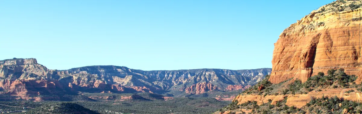Breathtaking view of the red rock formations and lush valley in Sedona, Arizona.