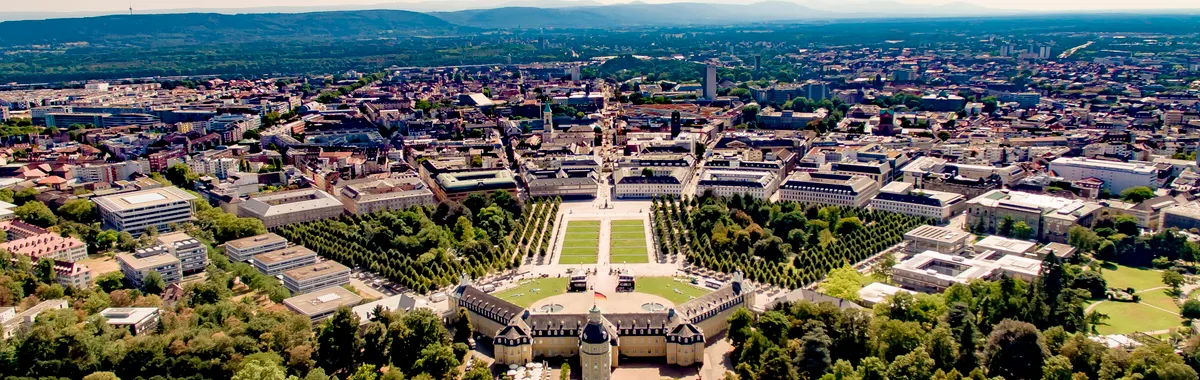 Aerial view showcasing Karlsruhe Palace and the surrounding cityscape with lush greenery.