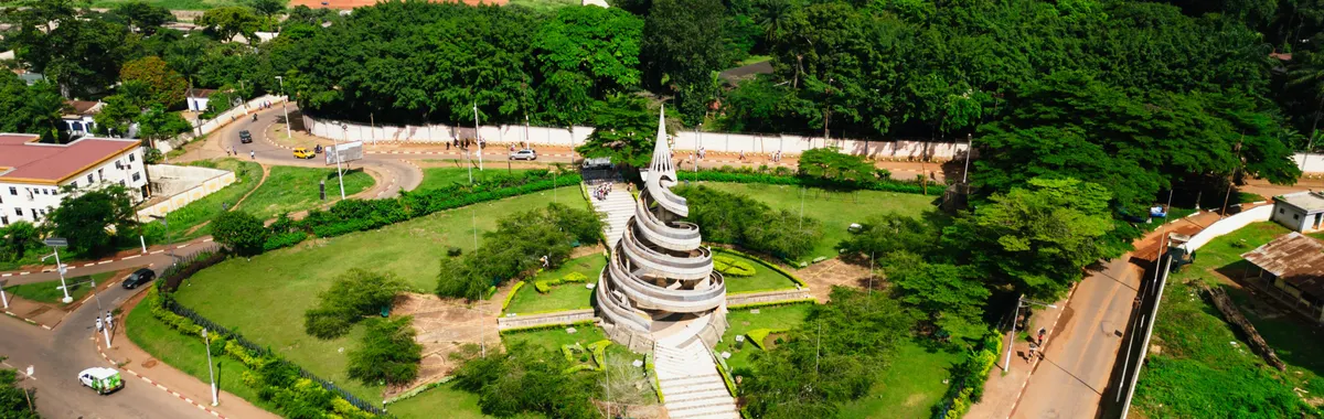A stunning aerial shot of the Reunification Monument surrounded by greenery in Yaoundé, Cameroon.
