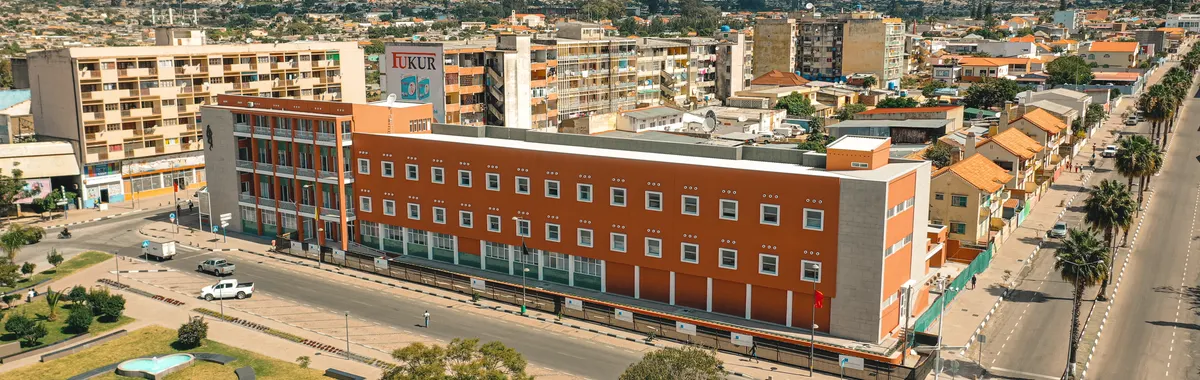 Explore the vibrant cityscape of Lubango, Angola, with mountains and urban architecture.