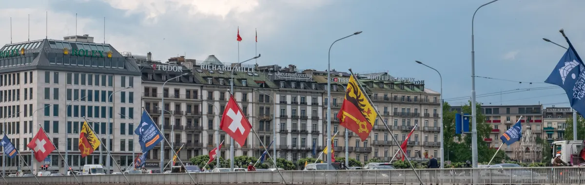 Capture of Mont-Blanc Bridge with flags and cityscape in Geneva, Switzerland.
