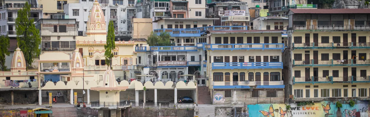 Vibrant buildings along the Ganges River in Rishikesh, India. A bustling urban scene with cultural charm.