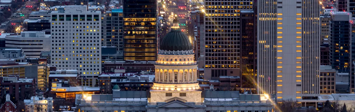 A breathtaking view of Salt Lake City's skyline illuminated at night, featuring the Utah State Capitol.