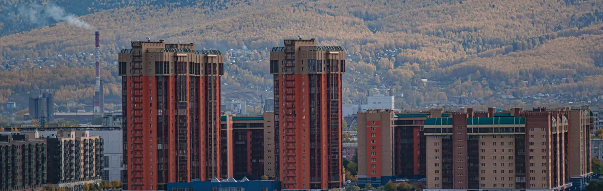 A stunning view of Krasnoyarsk cityscape featuring modern skyscrapers along the Yenisei River.