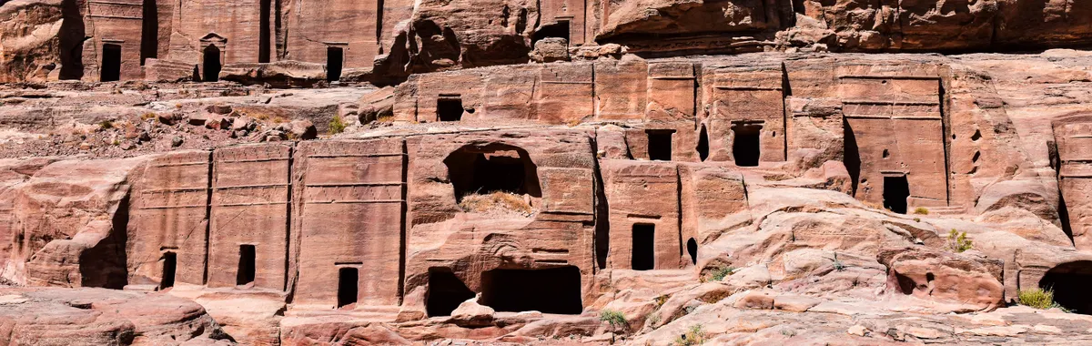 Discover the ancient rock-cut tombs in Petra, showcasing historical architecture in Jordan.