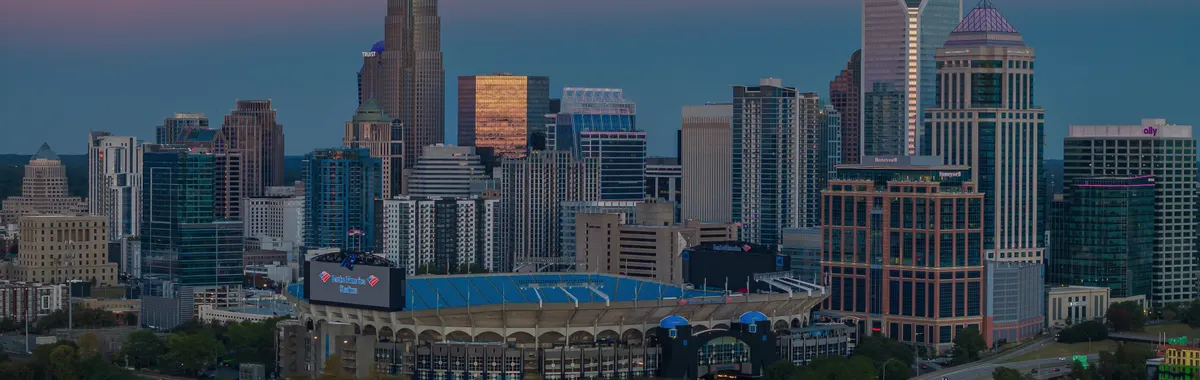 Aerial view of Charlotte skyline and Bank of America Stadium at dusk, North Carolina, USA.