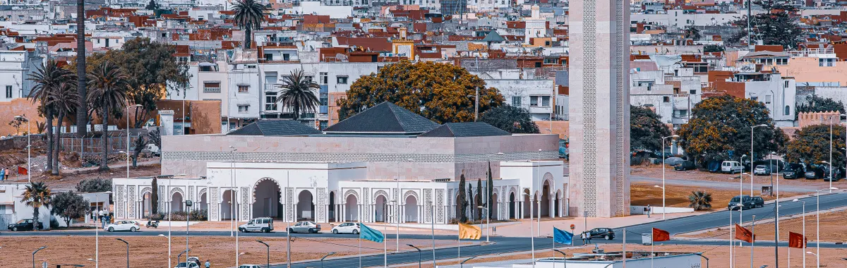 Scenic aerial panorama of Rabat, Morocco featuring a prominent landmark and cityscape.