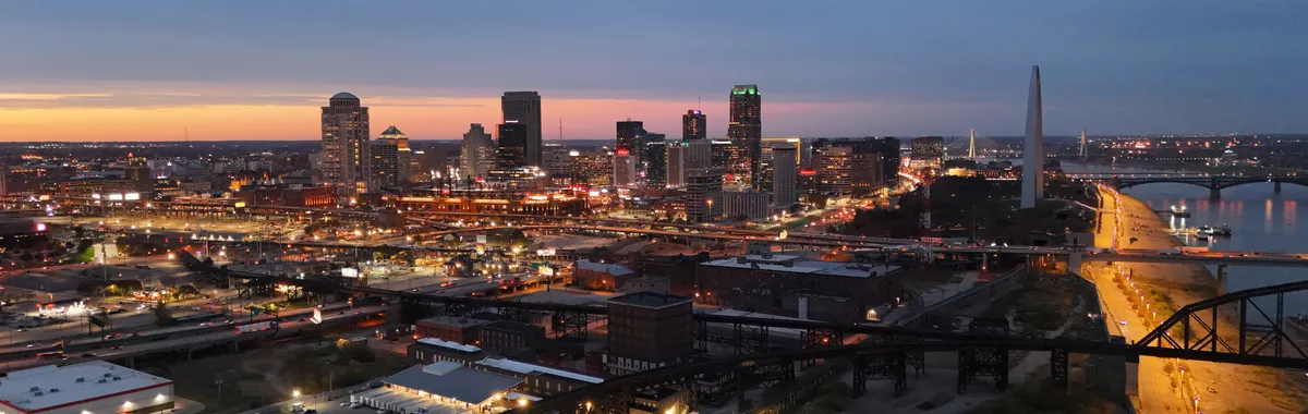 Aerial view of St. Louis skyline at night featuring the iconic Gateway Arch.