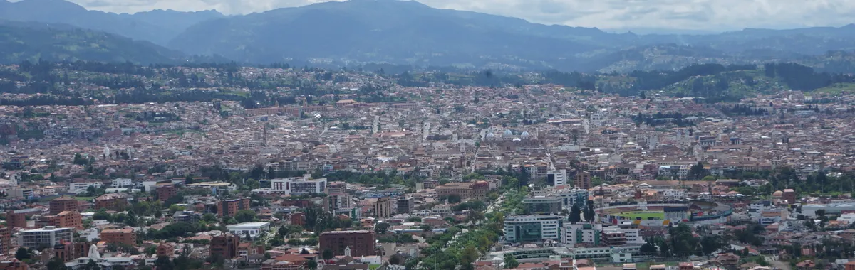 Stunning aerial view of Cuenca, Ecuador showcasing its dense urban landscape and mountainous backdrop.