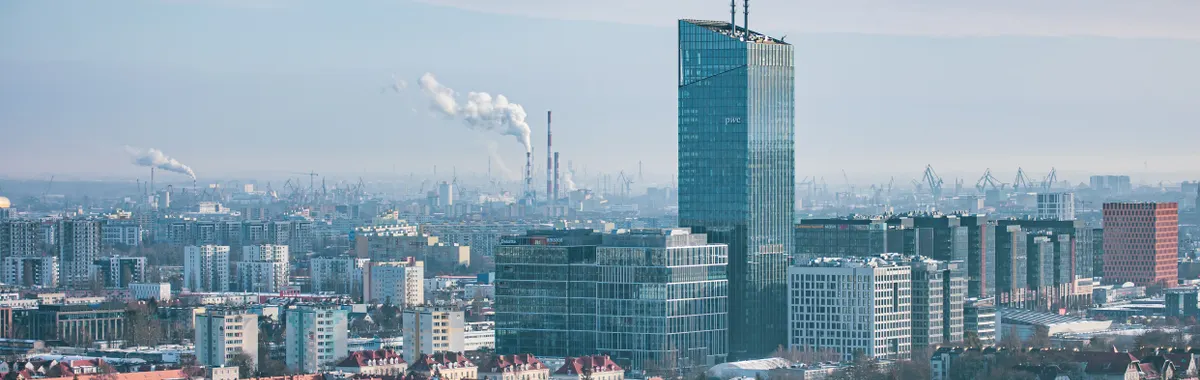 Panoramic aerial cityscape of Gdansk with skyscrapers and rooftops during winter.