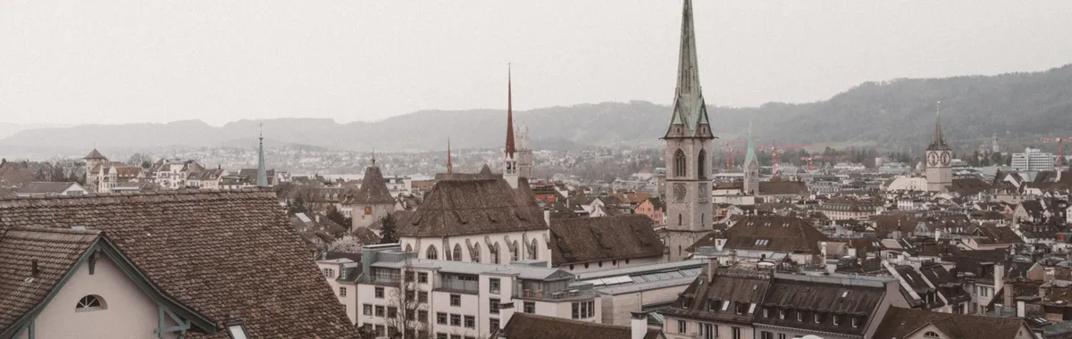 Aerial view of the picturesque old town of Zürich, highlighting historical architecture and iconic churches.