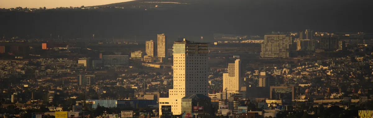 Explore the cityscape of Santiago de Querétaro, Mexico with its impressive buildings illuminated by the sunset glow.
