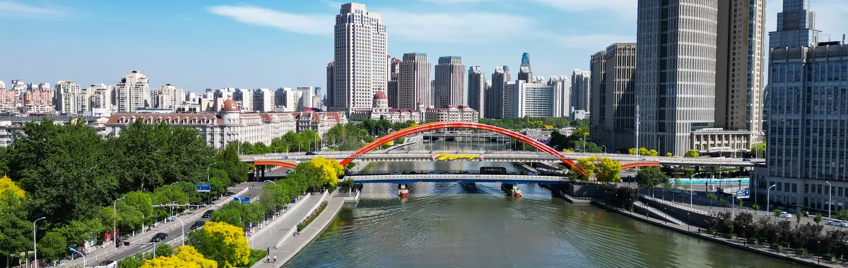 Stunning aerial view of Tianjin cityscape, featuring the Haihe River and modern architecture.