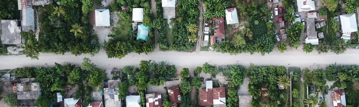 האיטי: Aerial view of lush rural area in Port-au-Prince, Haiti, showcasing greenery and houses.