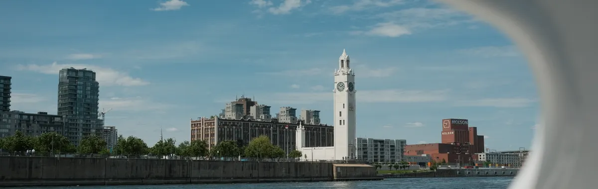 Scenic view of Montreal's iconic Clock Tower from the water on a clear day.