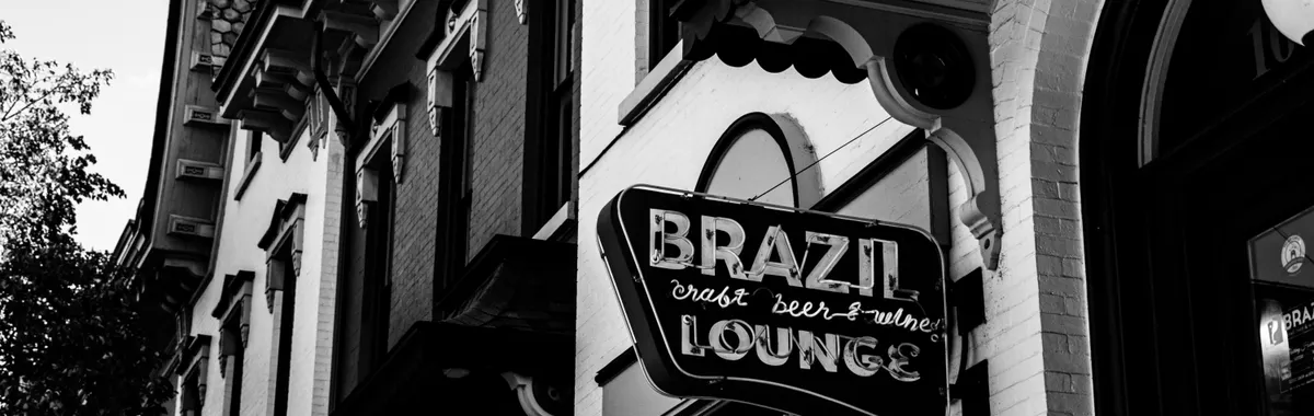 Black and white photo of the Brazil Lounge sign on a historic street in Jamestown, NY.