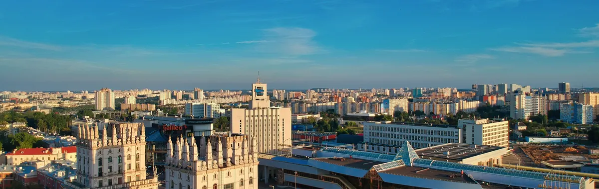 Stunning aerial view of Minsk featuring iconic buildings against a bright blue sky.