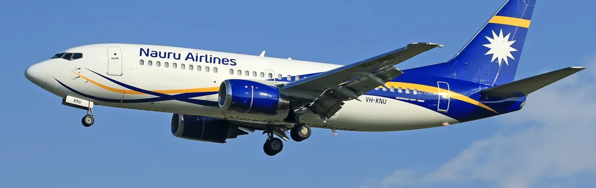 נאורו: Nauru Airlines jet flying mid-air with a clear blue sky backdrop.