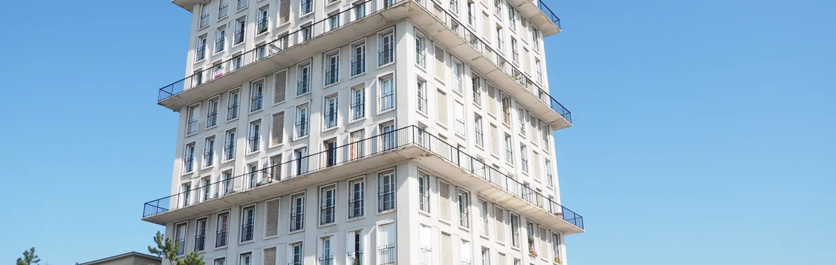 Mid-century modern building in Le Havre, showcasing minimalist design under a clear blue sky.