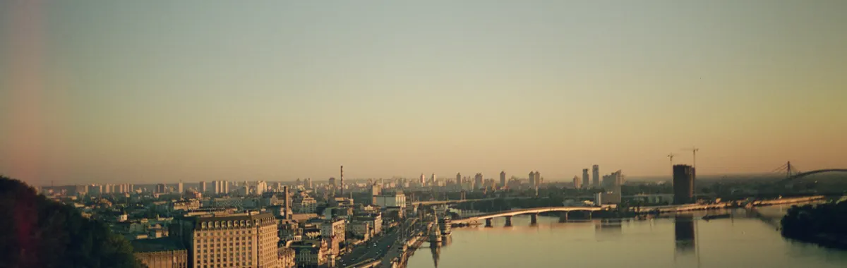 A stunning sunrise view over the Dnipro River in Kyiv, Ukraine, showcasing the city's skyline.