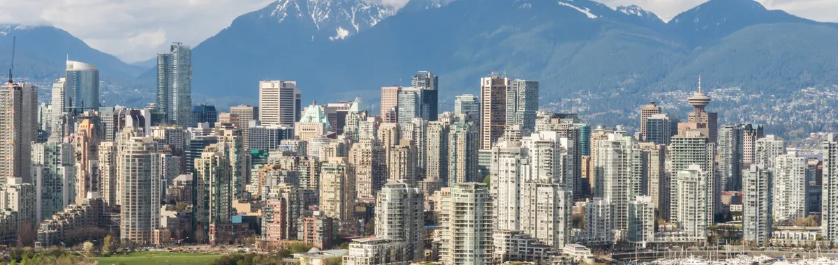 Stunning view of Vancouver's skyline with mountains and marina in the background.