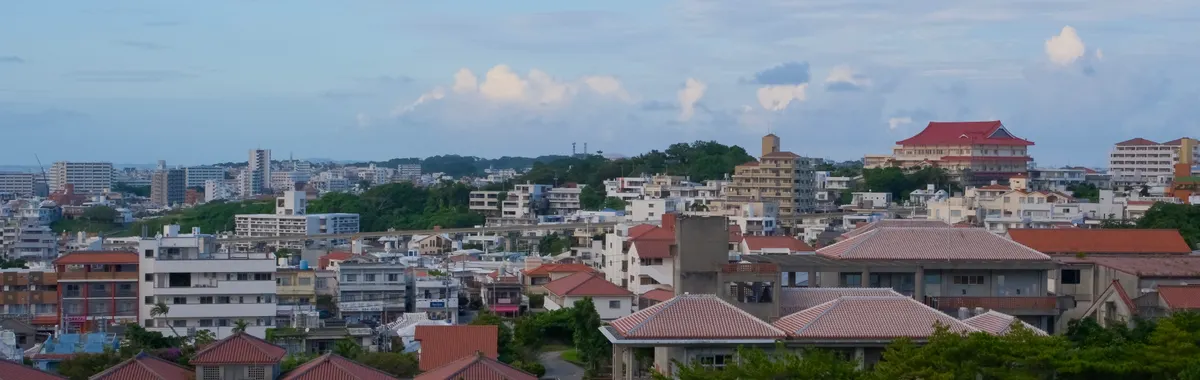 Panoramic view of Okinawa cityscape with traditional and modern buildings.