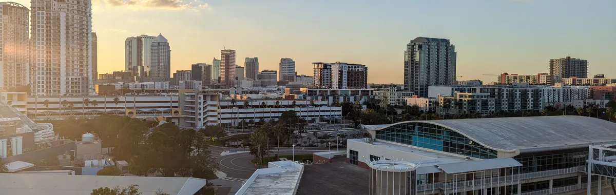 A stunning view of Tampa skyline at sunset, highlighting modern architecture and urban landscape.