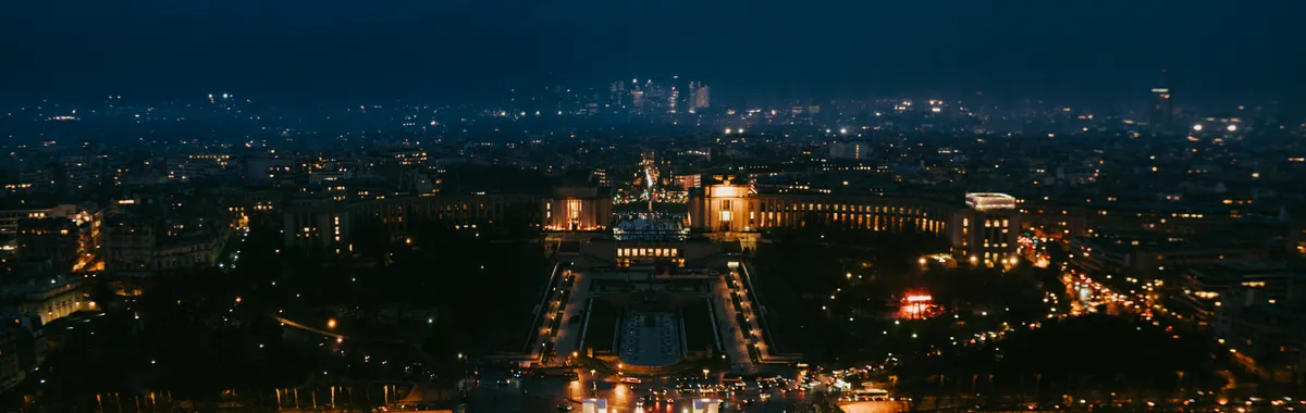 Stunning nighttime aerial cityscape of Paris highlighting iconic landmarks.