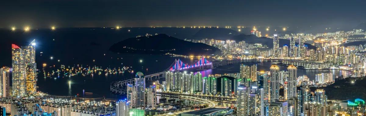 Stunning view of Busan's illuminated skyline and Gwangan Bridge at night in South Korea.