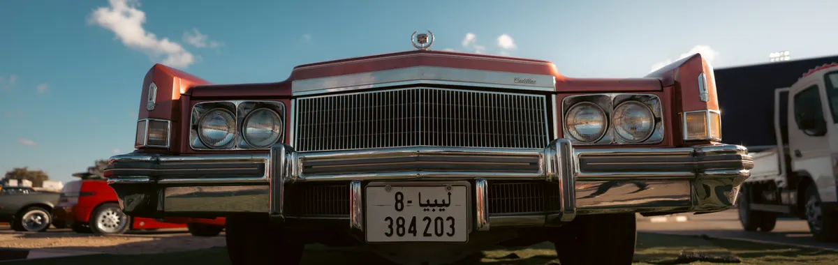 A classic 1970s red Cadillac with chrome details in Benghazi, Libya.